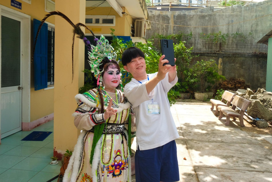 Giáo viên người Nhật Bản thích thú chụp ảnh lưu niệm cùng nghệ nhân hát bội. Ảnh: Ngọc Nhuận dscf1546.jpg