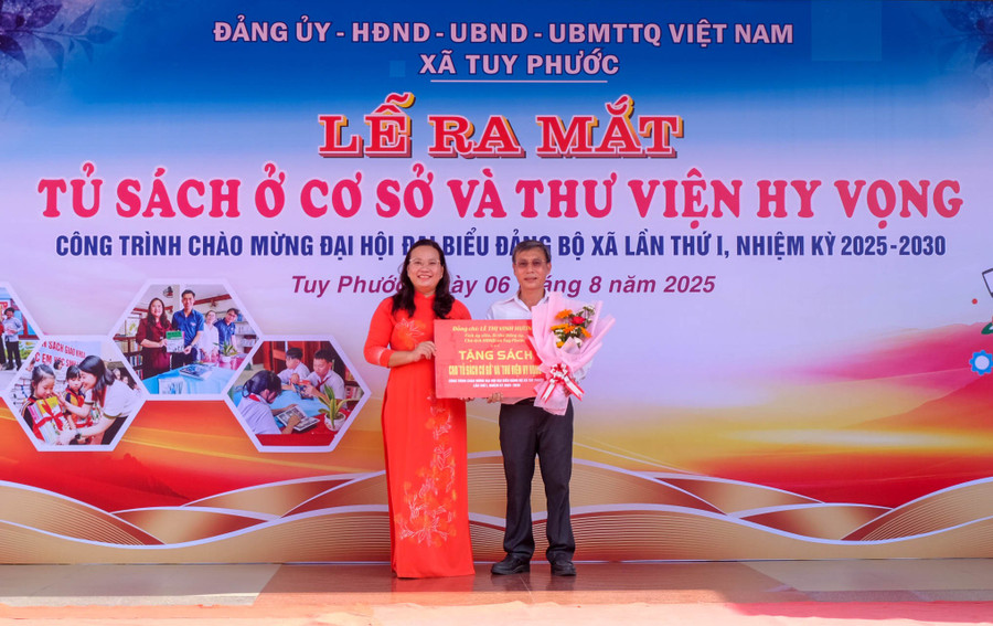 Bà Lê Thị Vinh Hương, Bí thư Đảng ủy xã Tuy Phước trao tặng sách của xã cho Tủ sách và Thư viện Hy vọng. Ảnh: Ngọc Nhuận dscf2202.jpg
