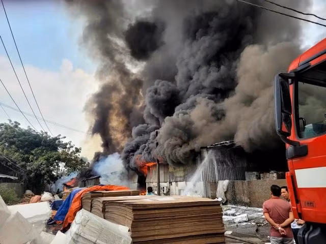 Ngọn lửa và cột khói cuồn cuộn bốc lên từ khu nhà xưởng