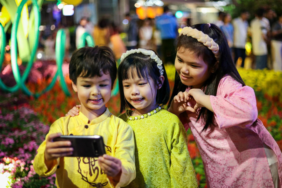 Các em nhỏ cũng hào hứng check in ở đường hoa Nguyễn Huệ năm nay