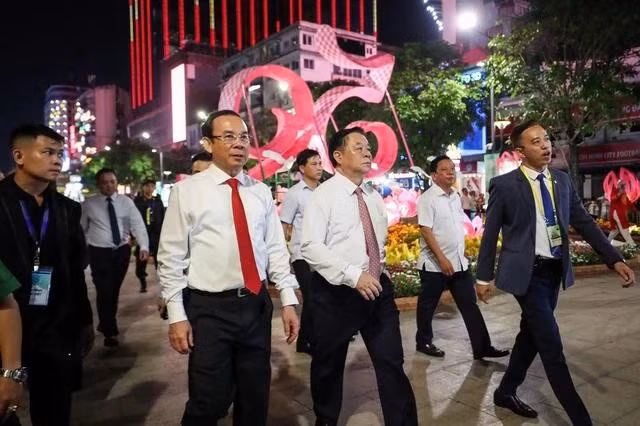 Ủy viên Bộ Chính trị, Trưởng ban Tuyên giáo Trung ương Nguyễn Trọng Nghĩa; Ủy viên Bộ Chính trị, Bí thư Thành ủy TP.HCM Nguyễn Văn Nên tham quan đường hoa Nguyễn Huệ