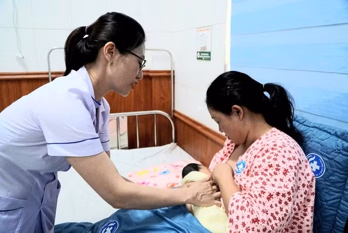 Cán bộ y tế hướng dẫn nuôi con bằng sữa mẹ. Ảnh: MOH