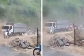 Tài xế dùng xe tải chắn nước lũ giúp bà con qua đường