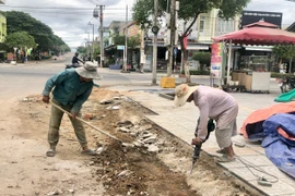 Đơn vị thi công đang hoàn thiện vỉa hè đường Nguyễn Thị Minh Khai. Ảnh: L.N