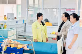 Y-bác sĩ Bệnh viện Nhi tỉnh động viên chị Siu Bếp (bìa trái, làng O Grưng, xã Ia Ko, huyện Chư Sê) cố gắng cho con nằm viện điều trị. Ảnh: N.N