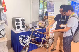 Anh Phạm Sơn Lộc (trái) giới thiệu về xe đạp trợ lực