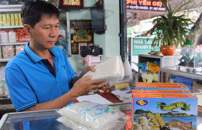 Còn đây mía ngọt, đường thơm - Ảnh 3. Anh Nguyễn Công, chủ cơ sở kinh doanh hàng đặc sản Quảng Ngãi Hoàng Yến, với sản phẩm đường phổi, đường phèn chế biến từ mía đường Quảng Ngãi
