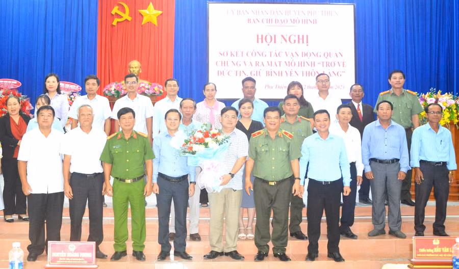 Các đại biểu tặng hoa chúc mừng huyện Phú Thiện ra mắt mô hình “Trở về đức tin, giữ bình yên thôn, làng”. Ảnh: Hữu Trường