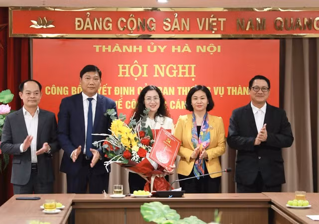 Ủy viên Trung ương Đảng, Phó Bí thư Thường trực Thành ủy Hà Nội Nguyễn Thị Tuyến trao quyết định và chúc mừng đồng chí Nguyễn Thị Huệ.