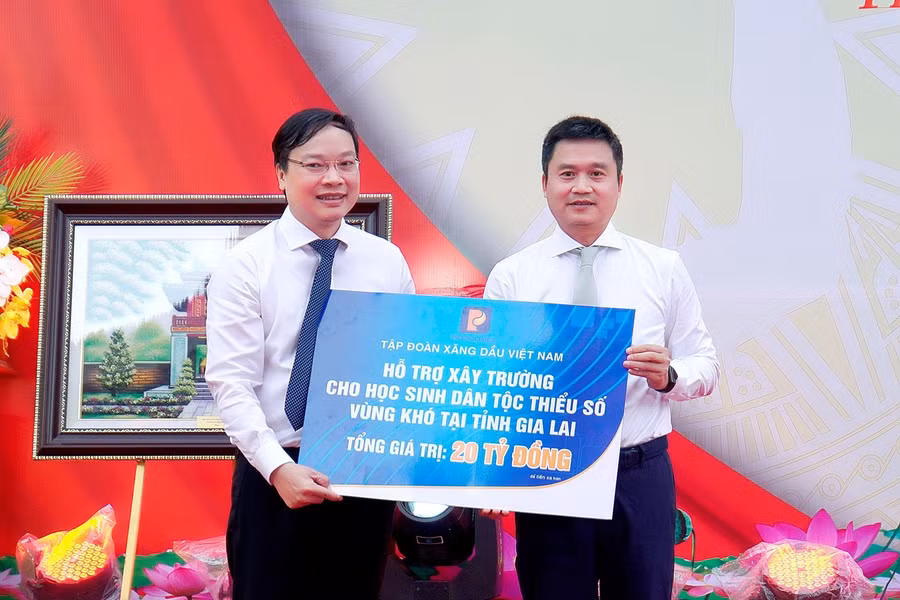 Thay mặt tỉnh Gia Lai, Chủ tịch UBND tỉnh Trương Hải Long (bìa trái) nhận bảng tượng trưng số tiền 20 tỷ đồng do Tập đoàn Xăng dầu Việt Nam hỗ trợ xây trường cho học sinh dân tộc thiểu số vùng khó tại tỉnh. Ảnh: Đức Thụy