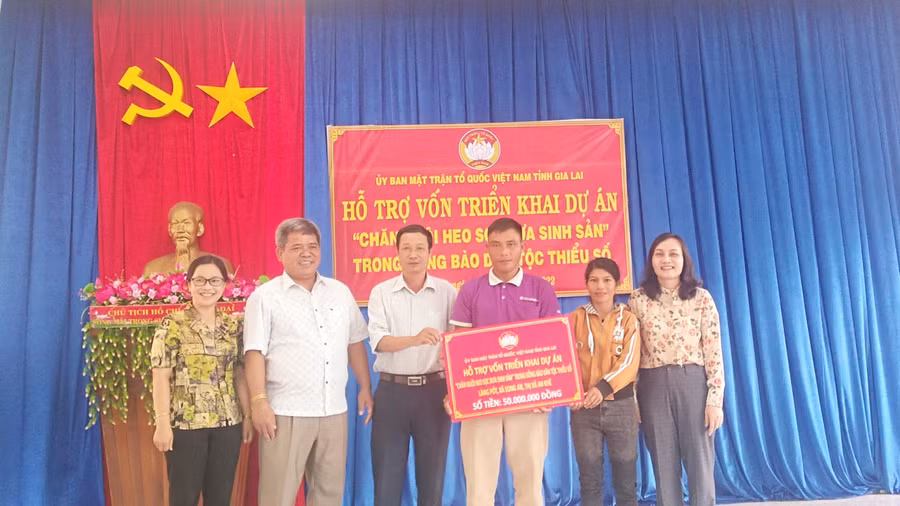 Chủ tịch Uỷ ban MTTQ Việt Nam tỉnh Hồ Văn Điềm (thứ 2 từ trái qua) trao kinh phí hỗ trợ thực hiện mô hình. Ảnh: Lê Đại