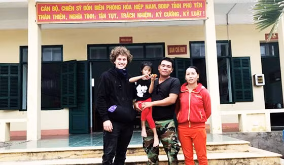 Anh Kainz bàn giao cháu bé N.T.Q.A. (7 tuổi) cho cha mẹ cháu. Ảnh: H.H