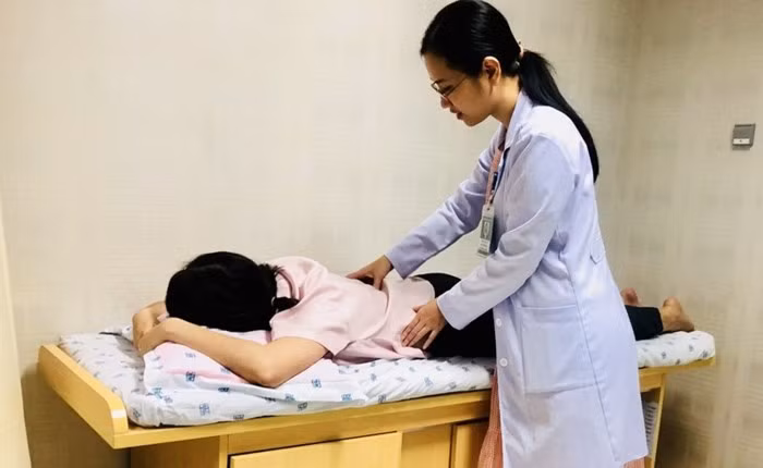 Bác sĩ đang thăm khám cho người bệnh đau lưng. Ảnh: NP Bác sĩ đang thăm khám cho người bệnh đau lưng. Ảnh: NP