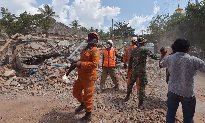 Các nhân viên cứu hộ khôi phục tìm kiếm người mất tích trong các đống đổ nát, không lâu sau khi trận động đất thứ ba xảy ra trưa 9-8. Ảnh: AFP