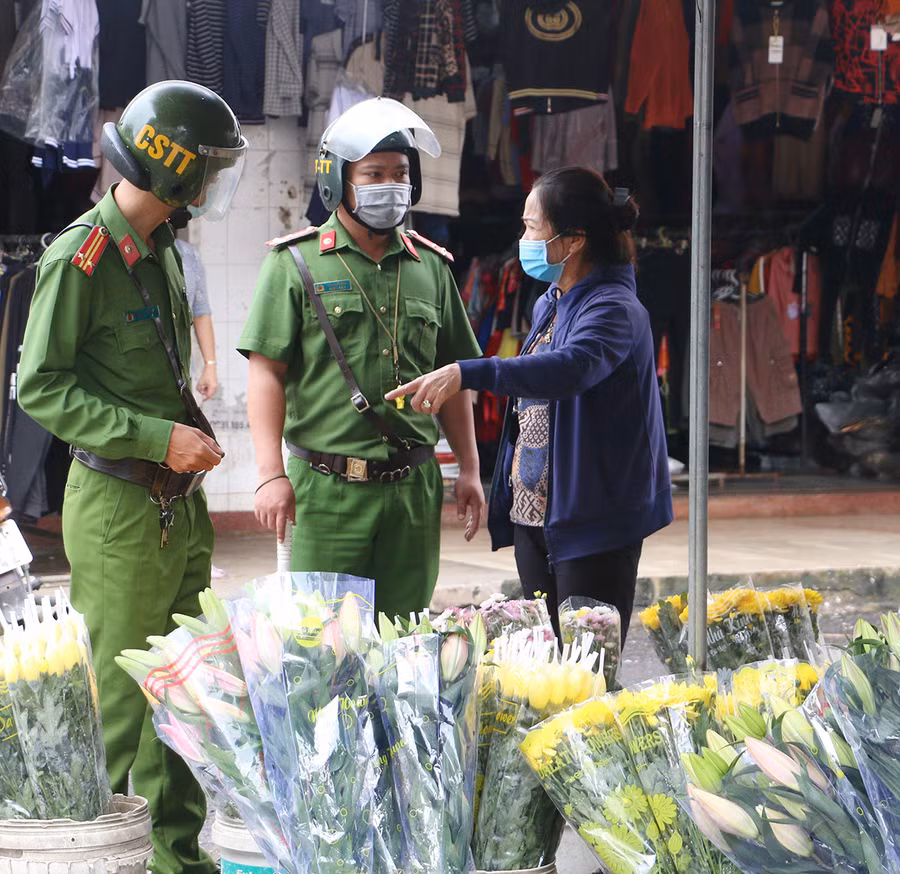 Lực lượng Công an yêu cầu tiểu thương tại Trung tâm Thương mại Pleiku đảm bảo an toàn phòng-chống dịch. Ảnh: Quang Tấn