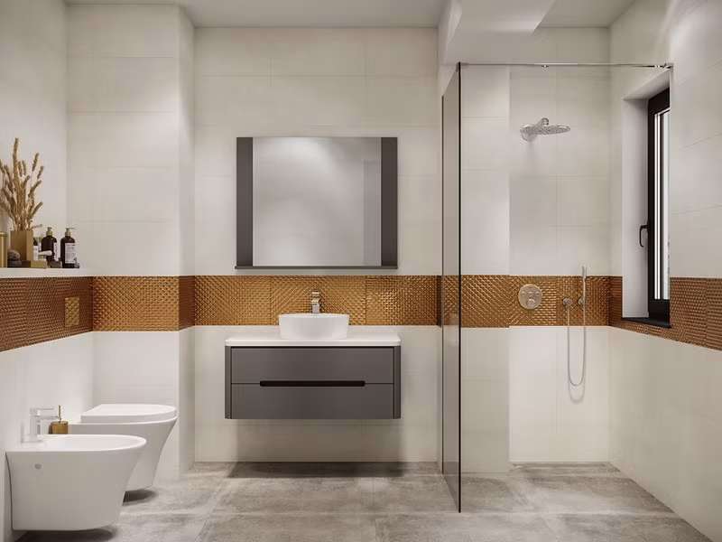 Mảng tường bọc vàng tạo sự liên kết, trong khi phòng tắm ướt và phòng tắm khô vẫn được ngăn cách bởi bức tường kính. Mảng tường bọc vàng tạo sự liên kết, trong khi phòng tắm ướt và phòng tắm khô vẫn được ngăn cách bởi bức tường kính.