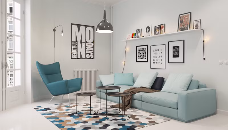  Căn phòng được thiết kế mang phong cách hiện đại, đơn giản gồm bộ bàn ghế sofa và những bức ảnh treo trên tường.