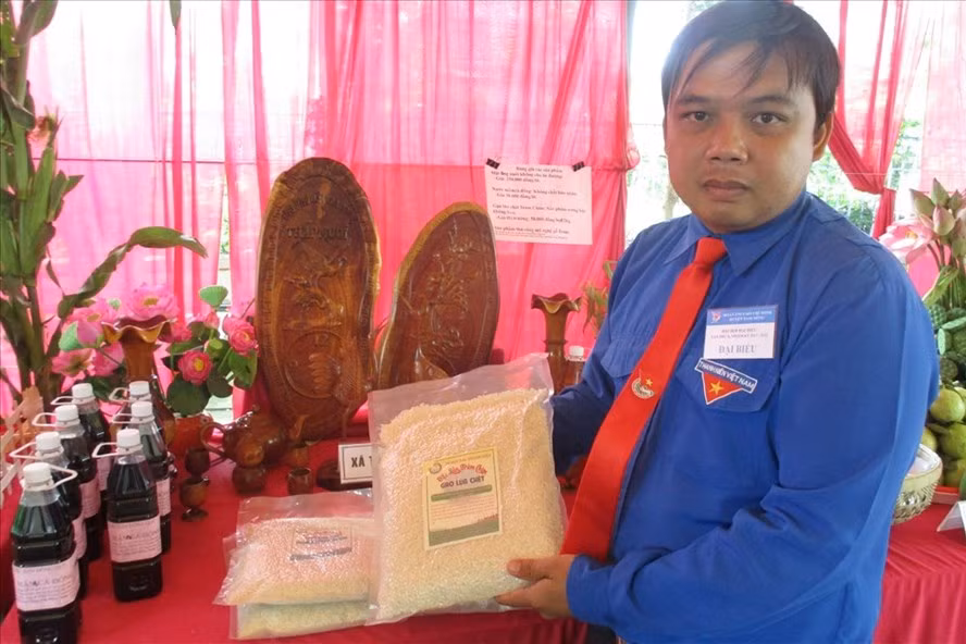 Nguyễn Thanh Hiếu và lúa chét Tràm Chim do anh sản xuất.
