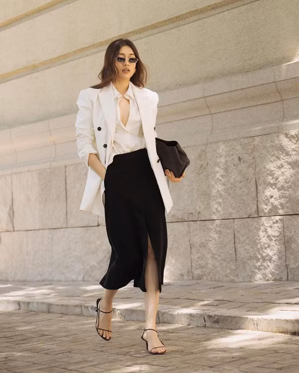 Hai gam màu trắng đen được Lệ Hằng phối hợp một cách hoàn hảo cho set đồ gồm sơ mi, vest và chân váy tông màu tương phản.