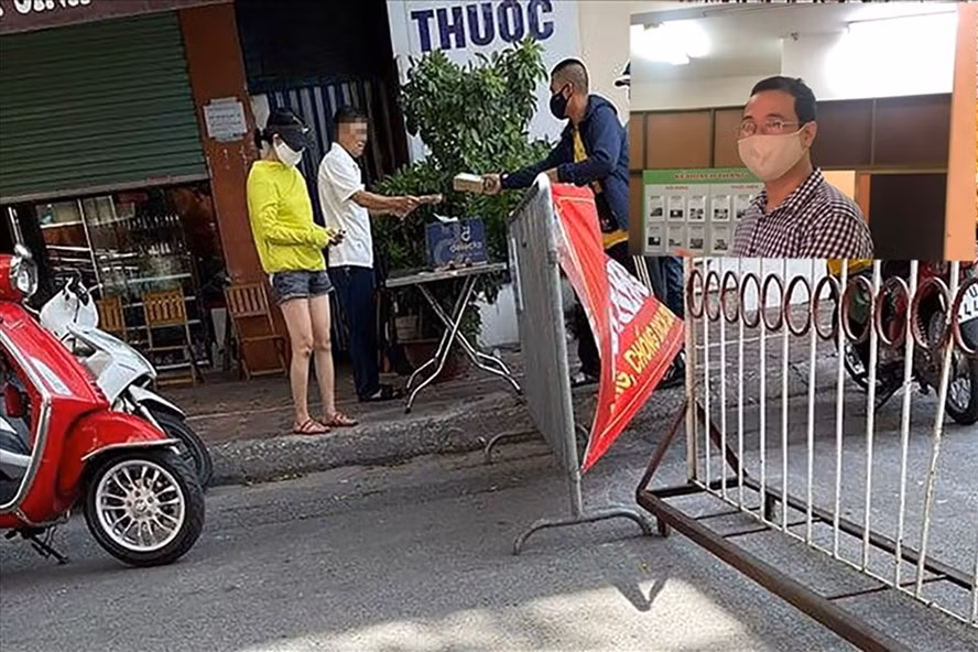 Chủ tịch UBND phường Tân Mai Nguyễn Thanh Tùng (ảnh nhỏ) ký quyết định xử phạt Bí thư Đảng uỷ phường Tân Mai (áo trắng) 2 triệu đồng vì vi phạm quy định phòng chống dịch COVID-19. Ảnh Thành Trung- PV