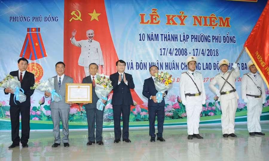  Ủy viên Ban Thường vụ Tỉnh ủy, Bí thư Thành ủy Trịnh Duy Thuân trao Huân chương Lao động cho Phường Phù Đổng. Ảnh: T.N