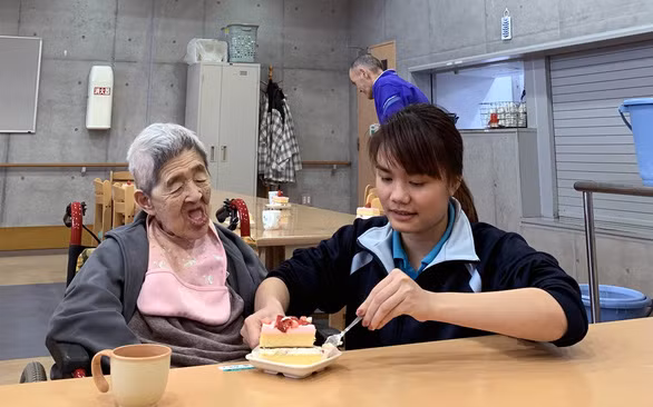 Hộ lý Nguyễn Thị Liên hỗ trợ người già ăn uống ở cơ sở chăm sóc người già Kofukai (tỉnh Yamanashi) - Ảnh: Đ.BÌNH