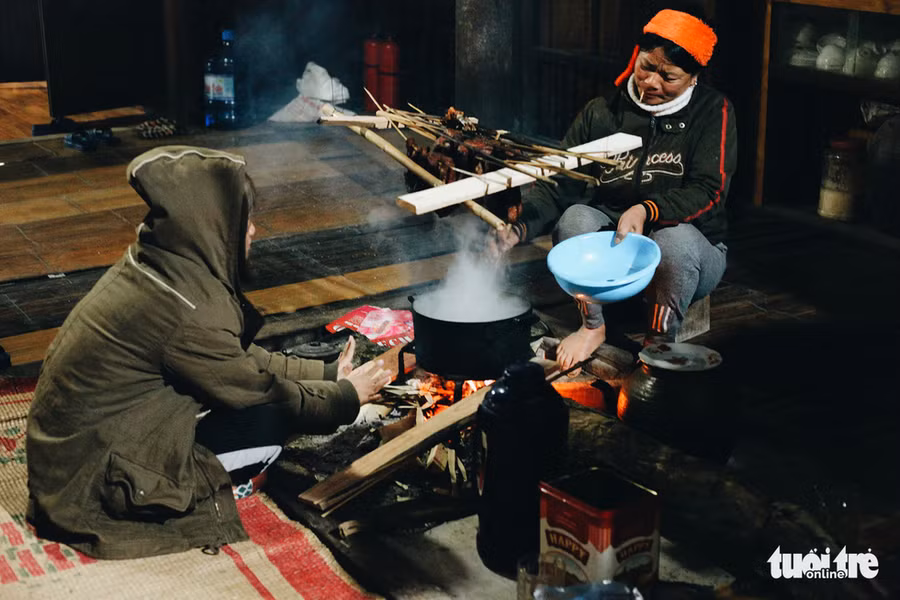 Quây quần bên bếp lửa chuẩn bị cho bữa tối cùng cô chủ nhà - Ảnh: CẨM TIÊN