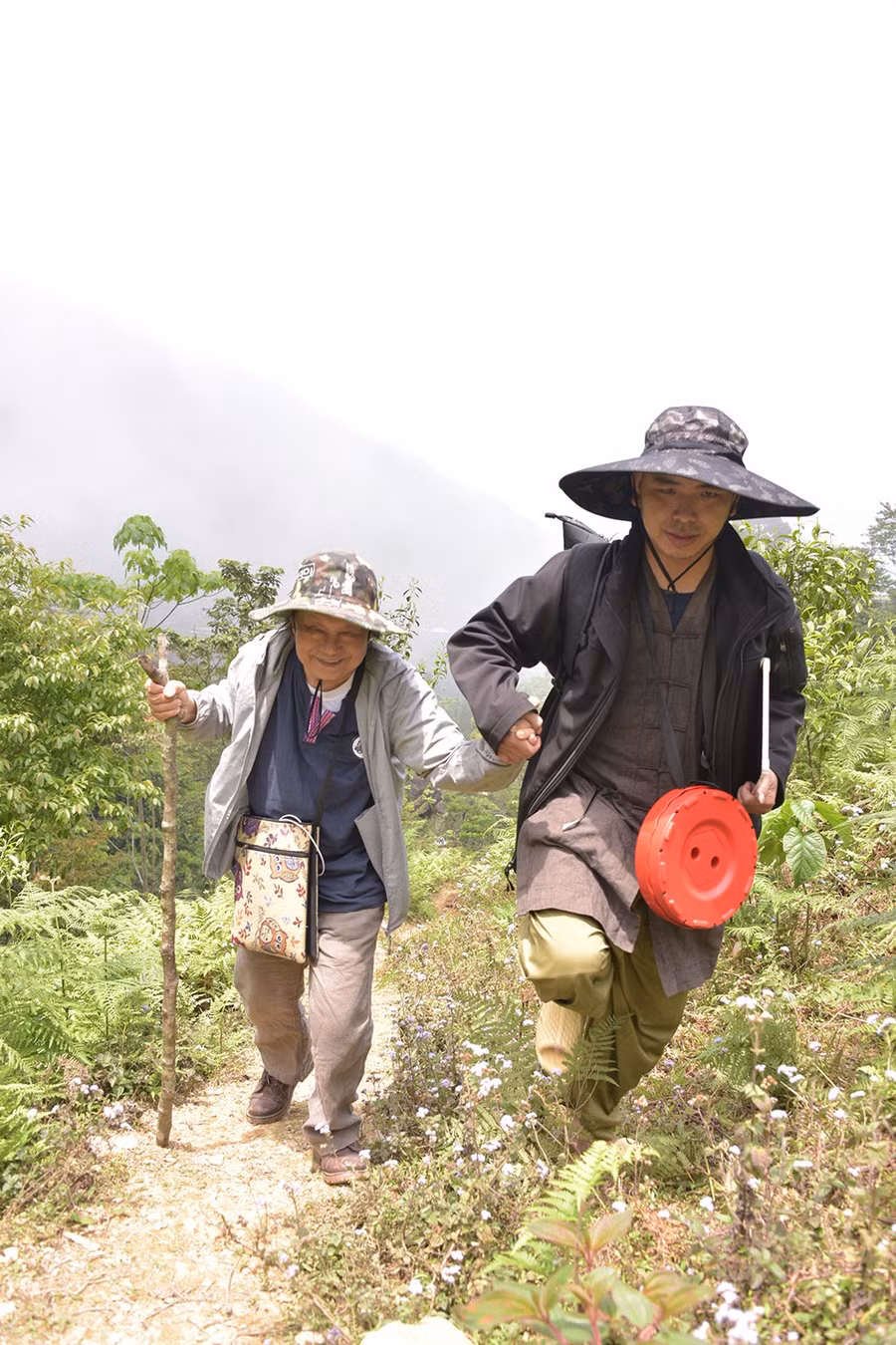 Họa sư Trương Lộ (trái), đã ngoài 70, cũng không nghĩ rằng mình có thể leo lên các dốc núi cao đi sáng tác.