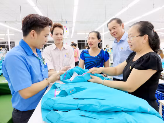 Chị Kim Dung (đứng giữa) trao đổi công việc tại xưởng cùng người lao động Chị Kim Dung (đứng giữa) trao đổi công việc tại xưởng cùng người lao động