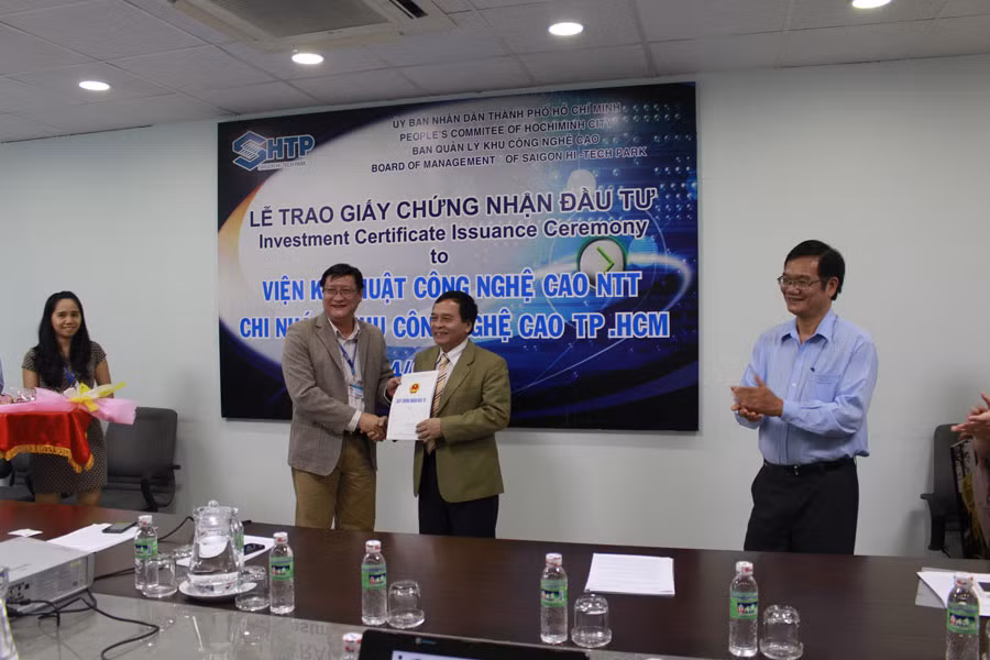 Lãnh đạo Khu Công nghệ cao TP. Hồ Chí Minh trao giấy chứng nhận đầu tư cho đại diện Viện Kỹ thuật Công nghệ cao NTT. Ảnh: Hoàng Liêm