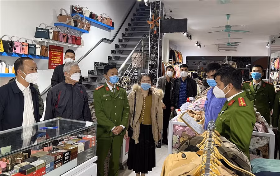 Thời điểm lực lượng công an thi hành lệnh khám xét tại shop quần áo Mai Hương. Ảnh: CATH