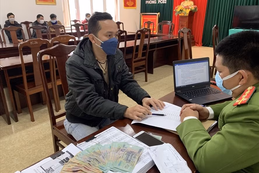 Các đối tượng trong tụ điểm đánh bạc bằng hình thức cá độ bóng đá tại cơ quan công an. Ảnh: Nguyên Hùng