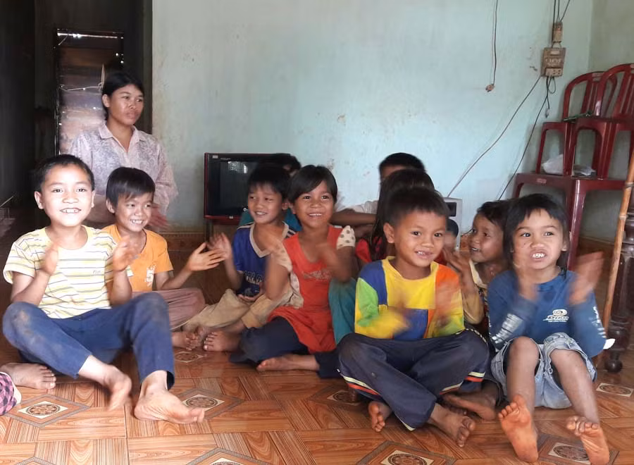 Vợ anh Rơ Chăm Hiếu cùng lũ trẻ con vui đùa trong ngôi nhà mình. Ảnh: Đỗ Hằng