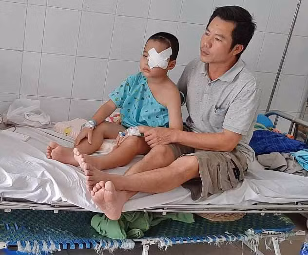  Cháu Hoàng Tấn Đạt đang được bố chăm sóc tại Bệnh viện Nhi đồng 2 (TP. Hồ Chí Minh). Ảnh: Phan Lài