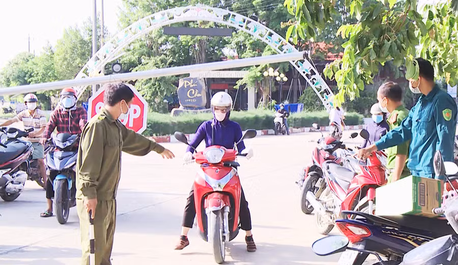  Lực lượng chức năng tại chốt kiểm soát liên ngành phòng-chống dịch bệnh Covid-19 giáp ranh giữa xã Phú Cần với thị trấn Phú Túc kiểm soát người ra vào vùng phong tỏa. Ảnh: Lê Nam