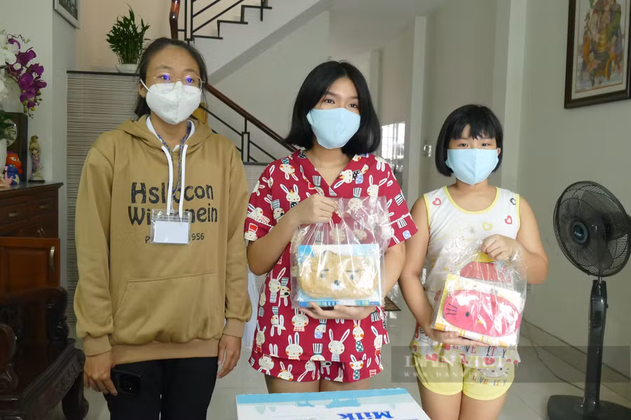 Đại diện UBND phường 5, quận Bình Thạnh tới nhà thăm hỏi và tặng quà cho hai bé Minh Vy và Minh Anh. Ảnh: Mỹ Quỳnh