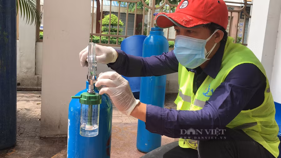 Kiểm tra bình oxy trước khi mang đến nhà dân tại quận 11. Ảnh: B.D