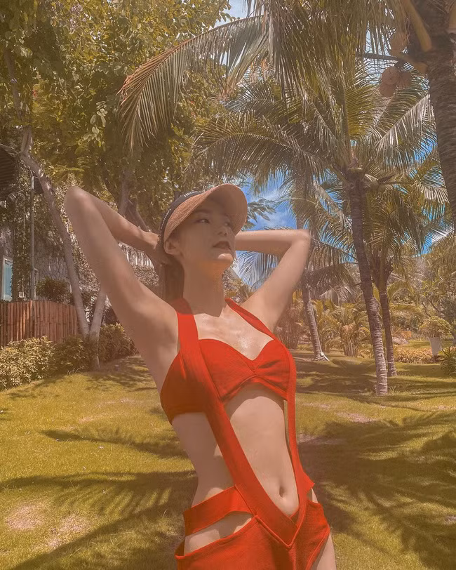 Minh Hằng gợi cảm trong bộ bikini đỏ rực được thiết kế độc đáo: “Enjoy relaxing in the sun” (Tạm dịch: Thư giãn trong ánh nắng mặt trời).