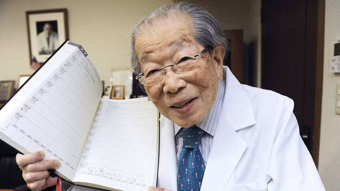 Bác sĩ Shigeaki Hinohara khoe cuốn sổ ghi chú bí quyết sống thọ - Ảnh: meddybear.net