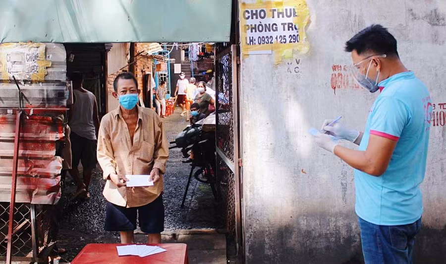 Người dân trong khu trọ ở hẻm 3/2 Nguyễn Văn Săng nhận quà từ nhà hảo tâm hồi tháng 9.2021. Ảnh: Đào Nguyên
