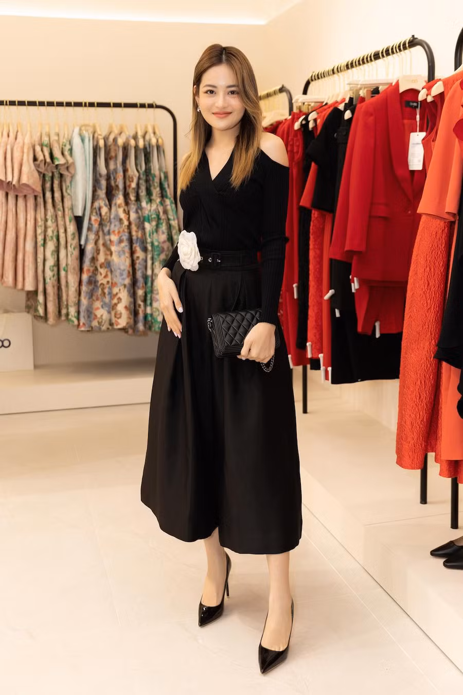 Diễn viên Thùy Anh vừa gợi cảm, vừa năng động với quần ống rộng đi kèm áo ôm khoét vai. Trên nền sắc đen, bông hoa trà trắng trở thành điểm nhấn. Ảnh: Huy Nguyễn, Đinh Trung Tín