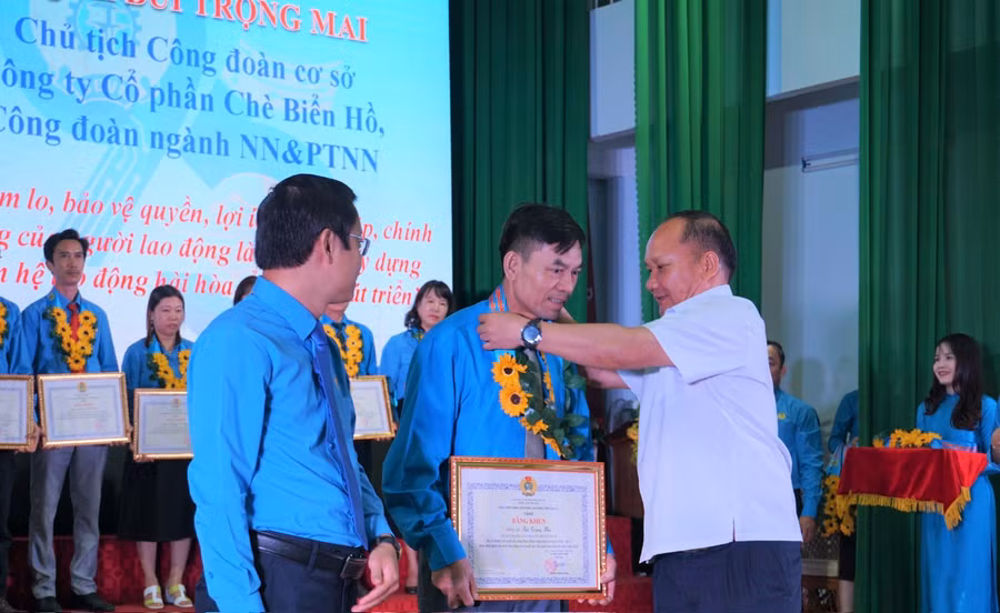 Phó Bí thư Tỉnh ủy Gia Lai Rah Lan Chung (bìa phải) và Chủ tịch LĐLĐ tỉnh Nguyễn Hoàng Phong tặng bằng khen và hoa cho các Chủ tịch CĐCS tiêu biểu tại buổi tuyên dương. Ảnh: Đinh Yến